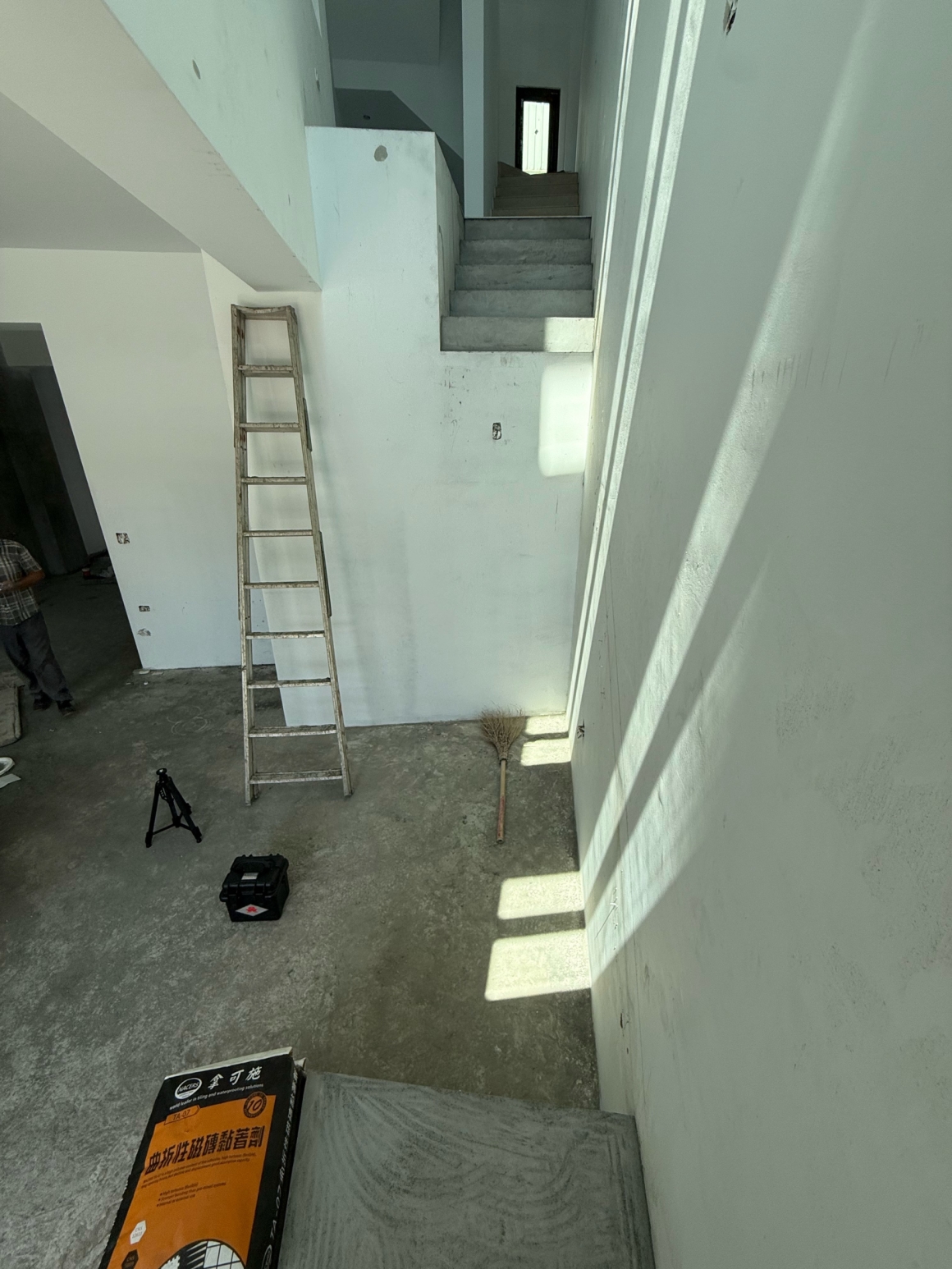 正邦鍛造南投龍骨梯現勘紀錄，住宅室內尚未安裝正式鋼構樓梯，現場可見上層既有混凝土階梯、白色牆面及一樓開放區域。此照片用來說明龍骨梯設計前必須確認上下樓層銜接位置、樓梯動線、牆面條件與施工空間，不能只依外觀照片直接決定尺寸。